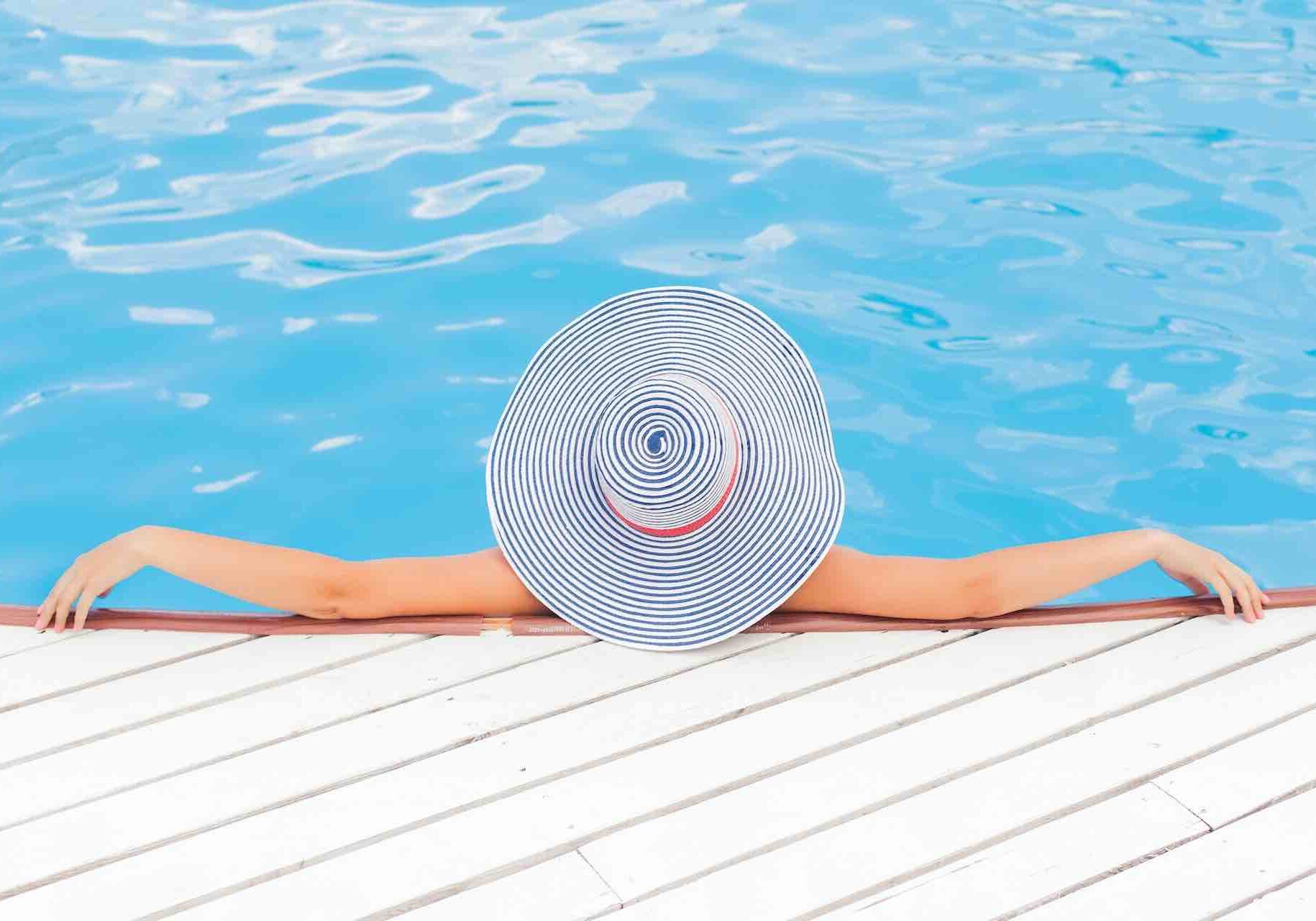 Woman with a hat in a solar heated pool.
